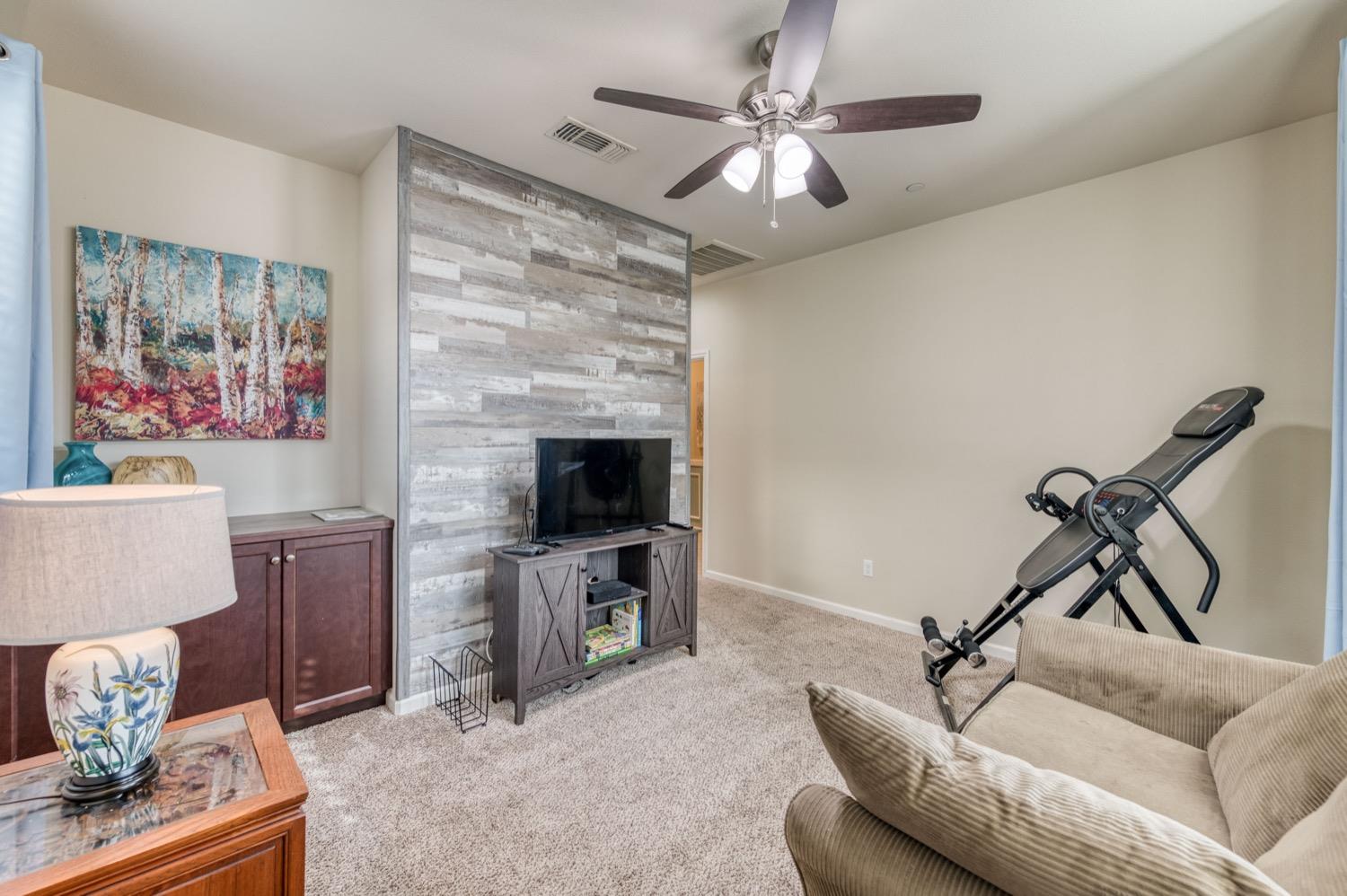 3610 Griffith Avenue Clovis, CA 93619 - Photo 12 of 22 a living room with furniture and a fireplace