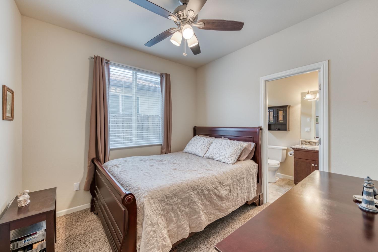 3610 Griffith Avenue Clovis, CA 93619 - Photo 13 of 22 a bedroom with a bed and a chandelier