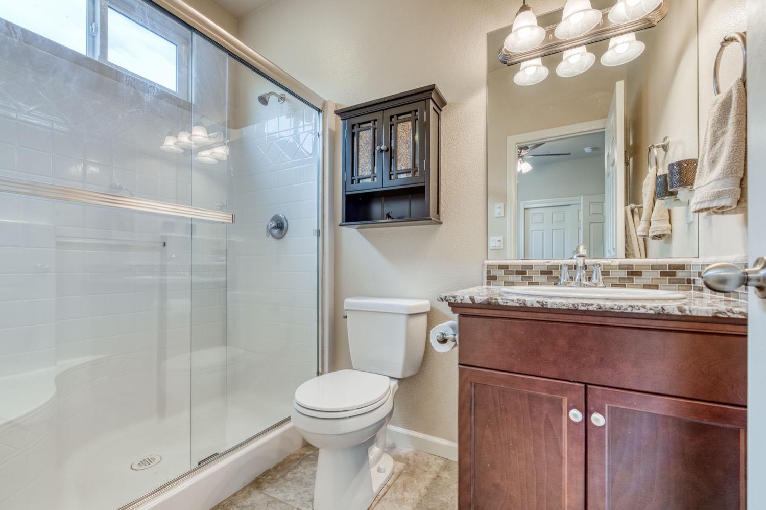 3610 Griffith Avenue Clovis, CA 93619 - Photo 14 of 22 a bathroom with a sink a toilet and shower