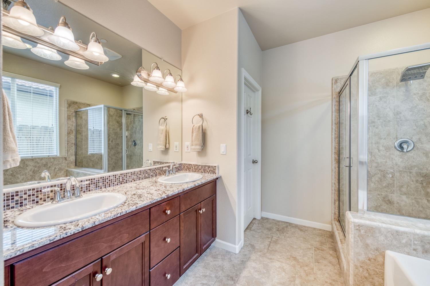 3610 Griffith Avenue Clovis, CA 93619 - Photo 18 of 22 a bathroom with a granite countertop sink mirror and double