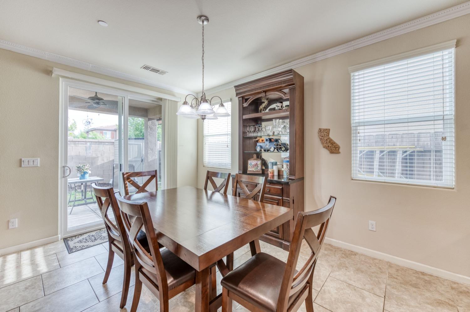 3610 Griffith Avenue Clovis, CA 93619 - Photo 9 of 22 a dining room with furniture a chandelier and window