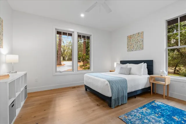 a spacious bedroom with a bed and a window