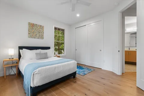 a bedroom with a bed and a painting