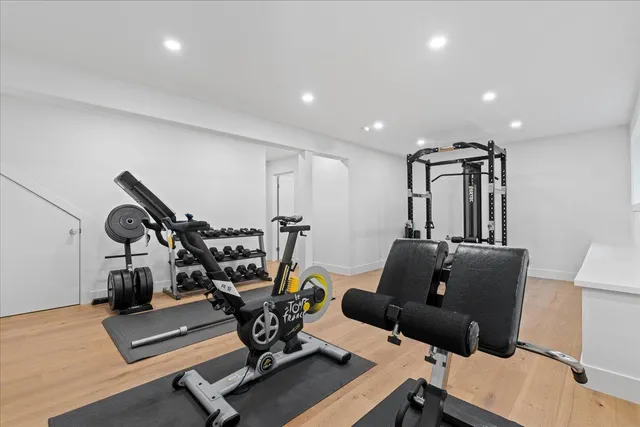 a living room with furniture and gym equipment