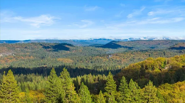 a view of mountain and green field