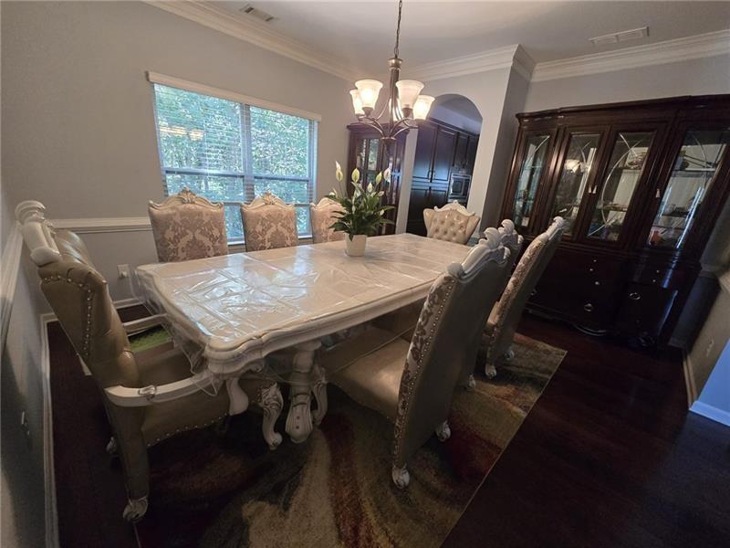 6850 Rocking Horse Lane Cumming, GA 30040 - Photo 10 of 36 a view of a dining room with furniture and chandelier