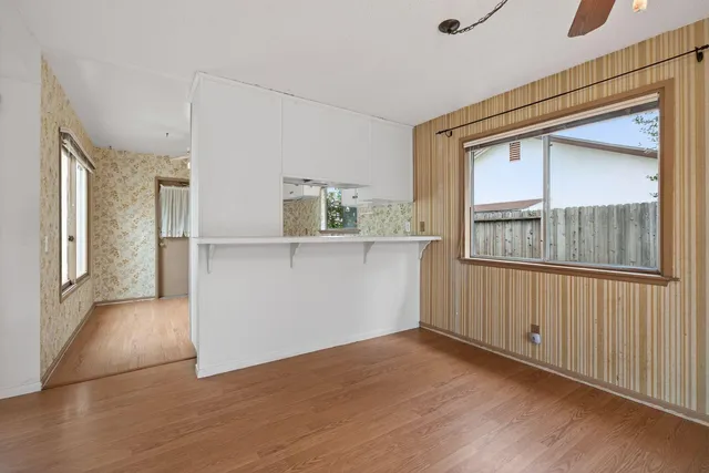 a view of a kitchen with wooden floor and windows
