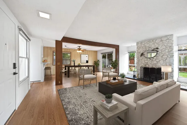 a living room with furniture a fireplace and a table