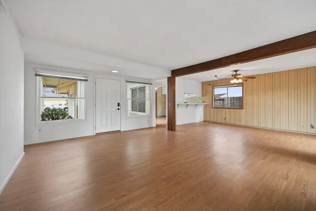 wooden floor in an empty room with a window