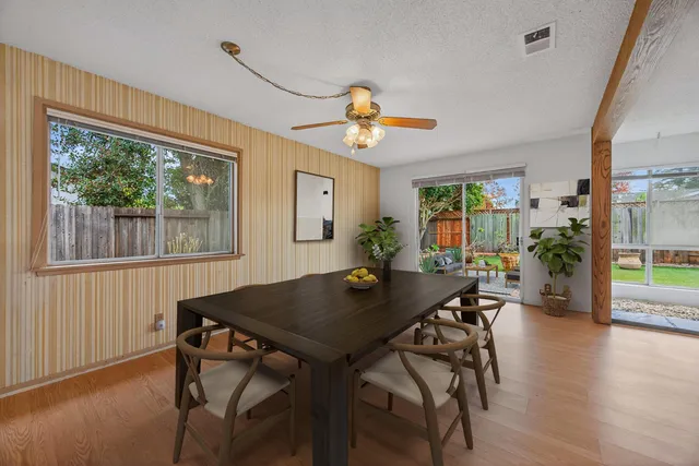 a view of a dining room with furniture window and wooden floor