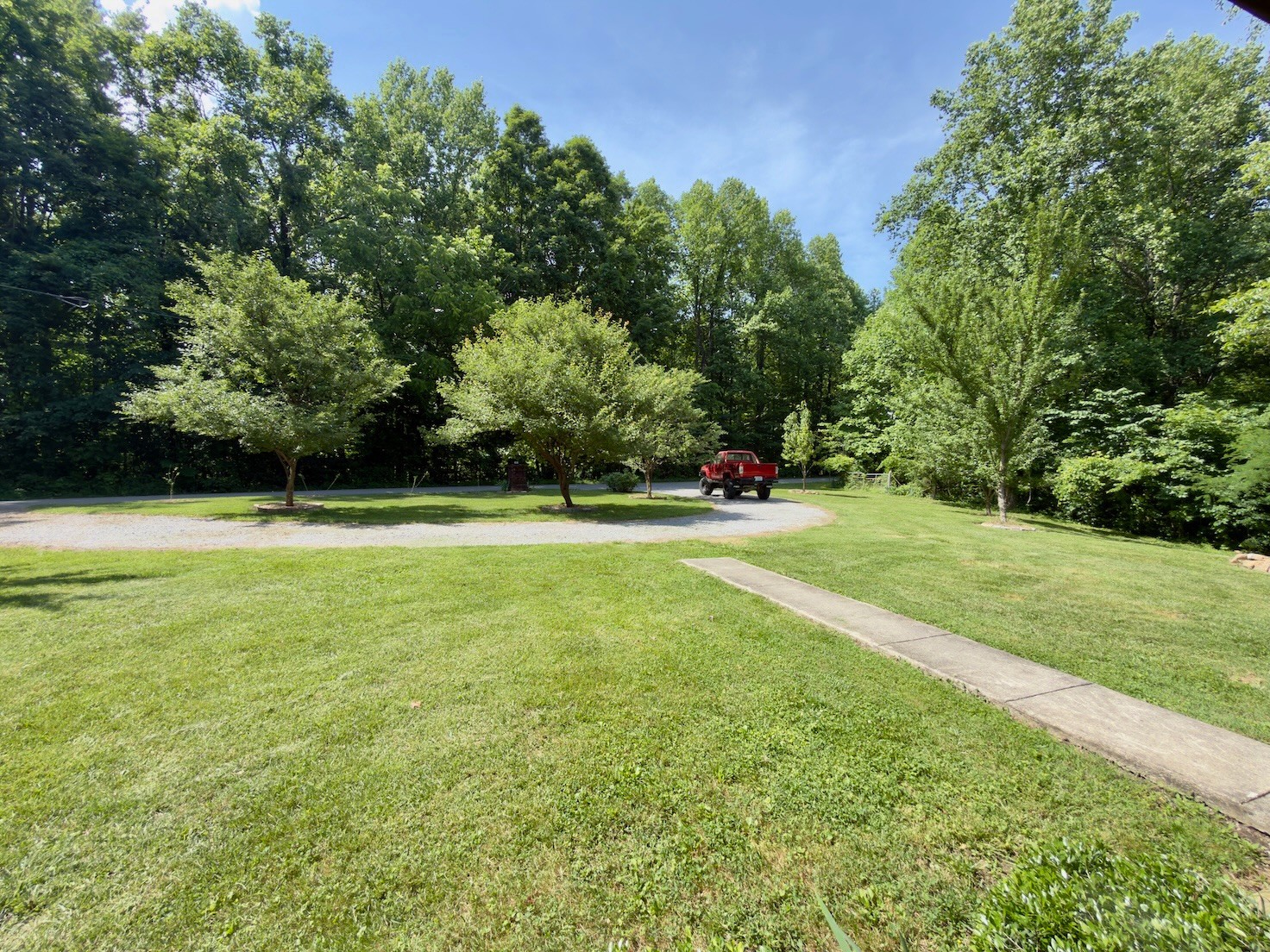 3080 Pleasant Ridge Road Woodbury, TN 37190 - Photo 7 of 19 a view of a green field with trees in the background