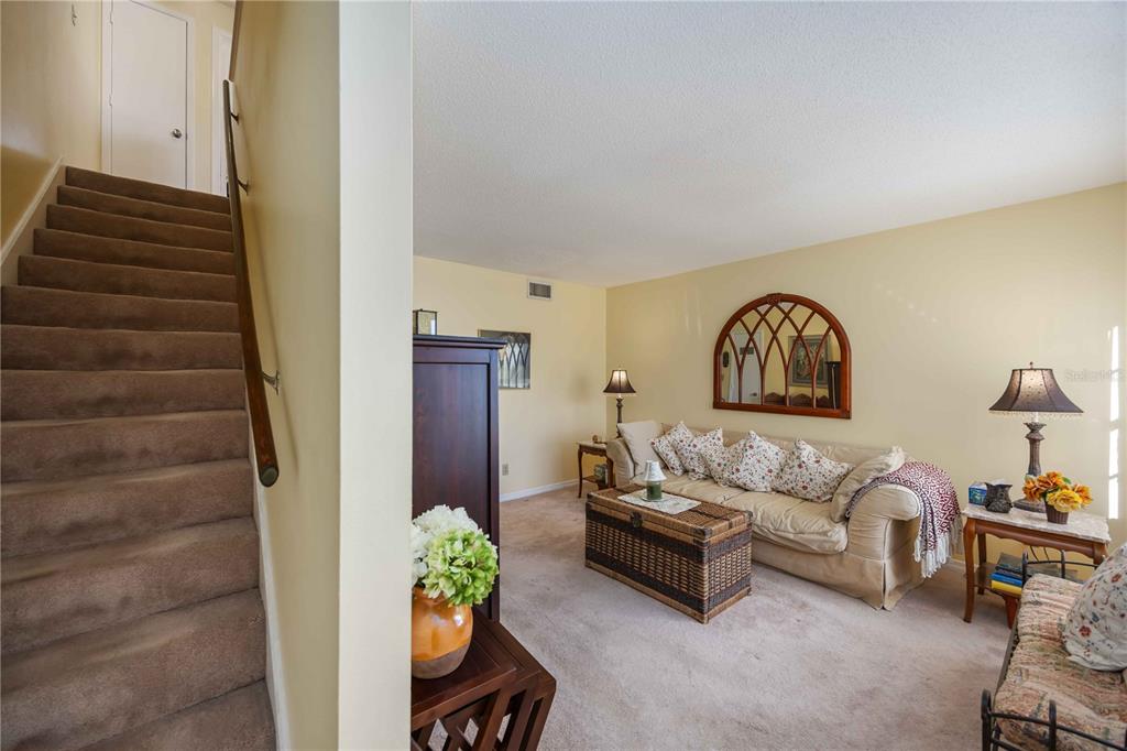 4885 Rilma Avenue, Unit 131 Sarasota, FL 34234 - Photo 11 of 25 a living room with furniture and a potted plant