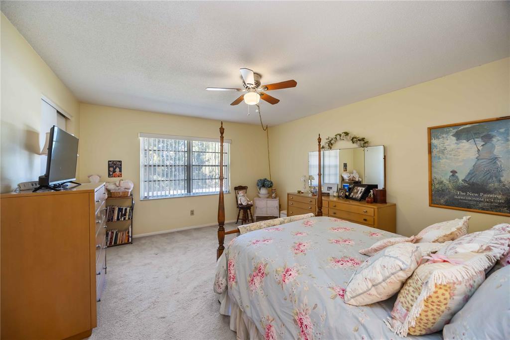 4885 Rilma Avenue, Unit 131 Sarasota, FL 34234 - Photo 13 of 25 a bedroom with a bed and a flat screen tv