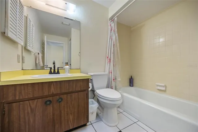 a bathroom with a sink mirror toilet and bathtub