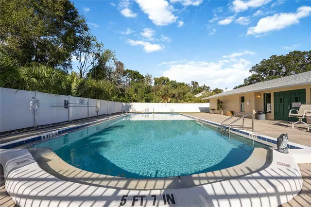 a view of a swimming pool with a patio