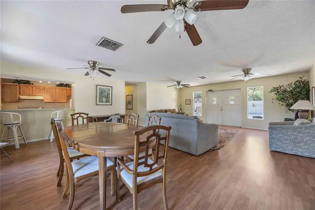 a dining room with furniture and wooden floor