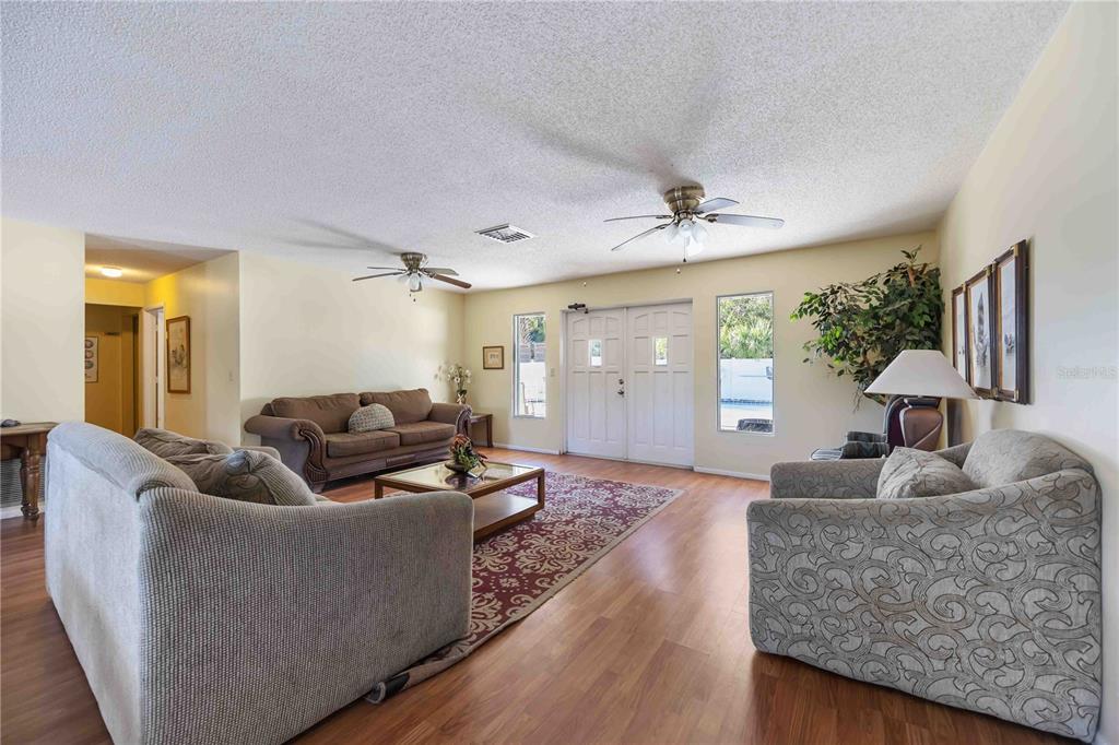 4885 Rilma Avenue, Unit 131 Sarasota, FL 34234 - Photo 20 of 25 a living room with furniture and a wooden floor