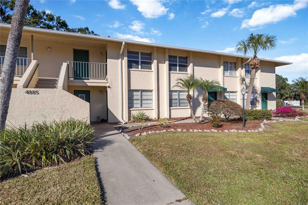 4885 Rilma Avenue, Unit 131 Sarasota, FL 34234 - Photo 2 of 25 a view of a house with backyard and sitting area