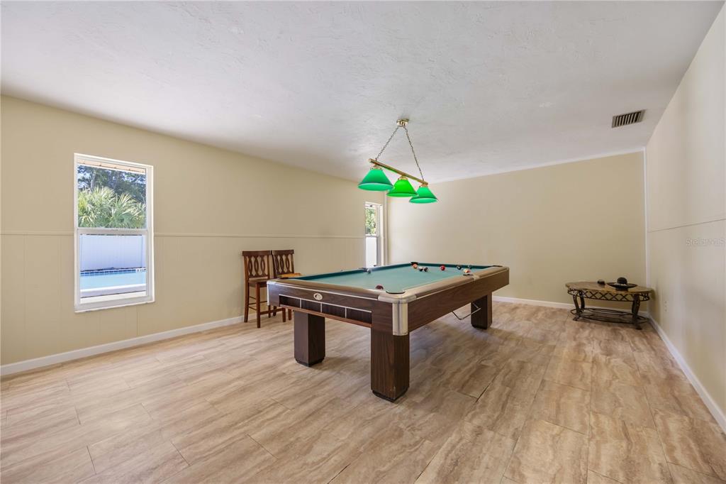 4885 Rilma Avenue, Unit 131 Sarasota, FL 34234 - Photo 21 of 25 a room with furniture and a wooden floor