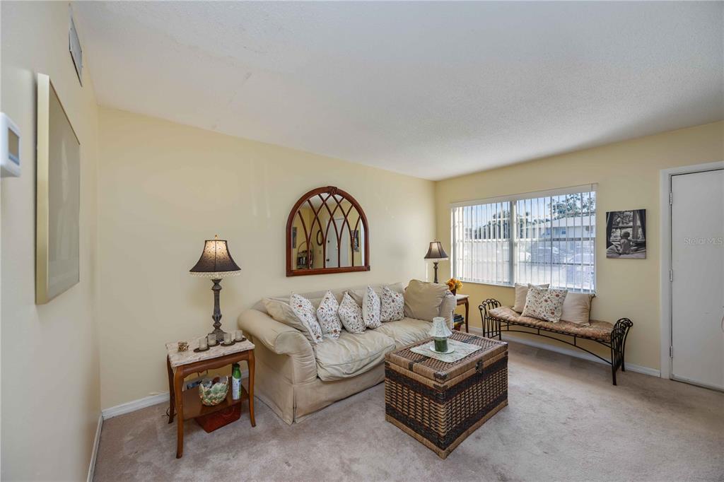 4885 Rilma Avenue, Unit 131 Sarasota, FL 34234 - Photo 4 of 25 a living room with furniture and a large window