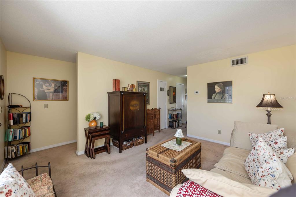 4885 Rilma Avenue, Unit 131 Sarasota, FL 34234 - Photo 5 of 25 a living room with furniture and a flat screen tv