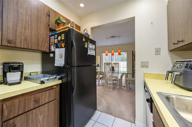 a kitchen with a refrigerator and a sink