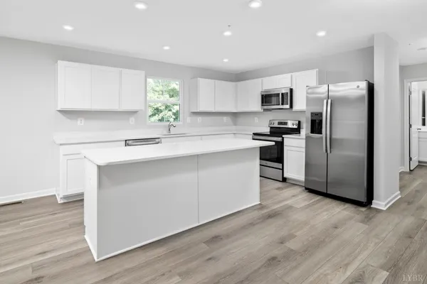 a kitchen with stainless steel appliances a refrigerator sink and microwave