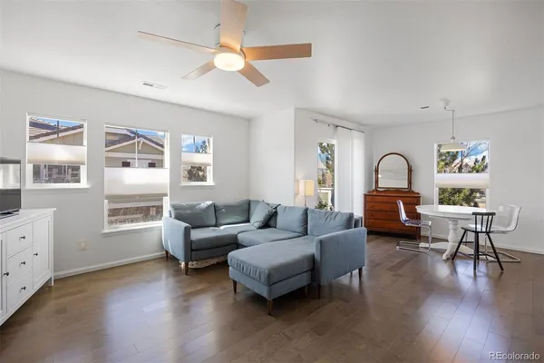 a living room with furniture and wooden floor