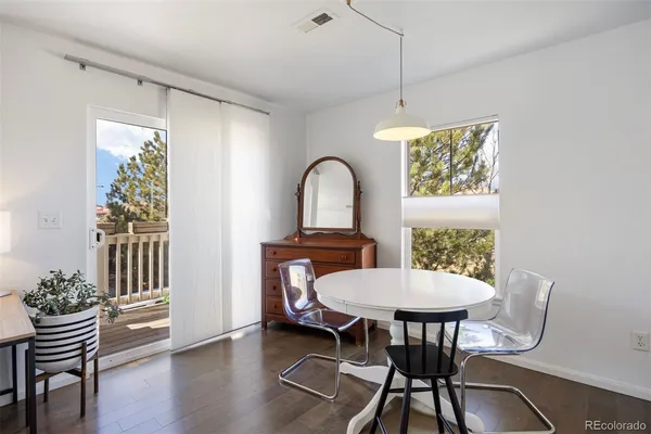 a view of a dining room with furniture window and wooden floor