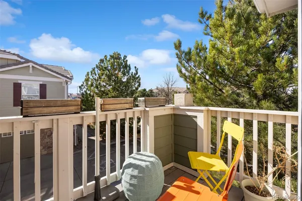 a view of a chairs and table in the balcony