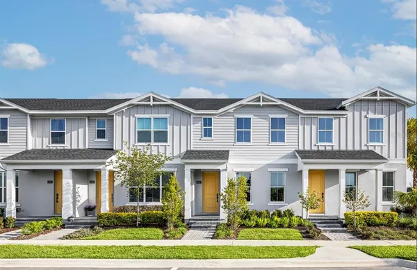 a front view of a residential houses with yard