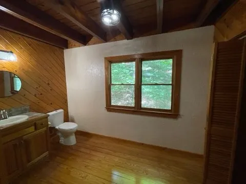 a white toilet sitting next to a bathroom sink and vanity
