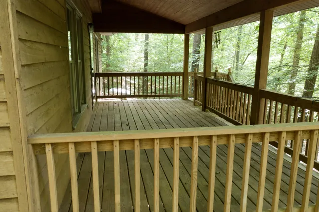 a view of a porch with furniture and floor to ceiling windows
