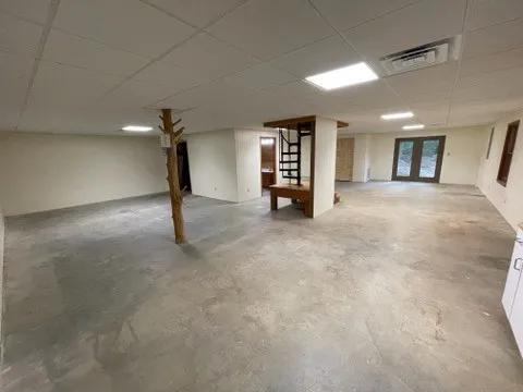 a view of a hallway with wooden floor and stairs