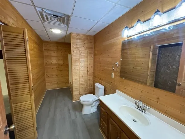 a bathroom with a sink a toilet a mirror and shower