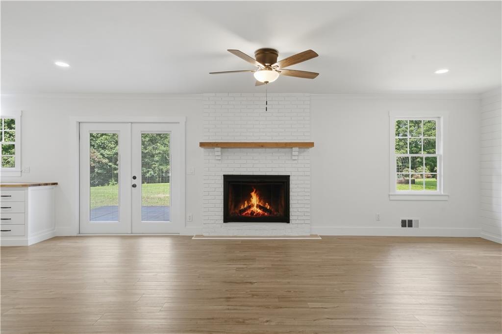125 Childers Road Canton, GA 30115 - Photo 11 of 48 an empty room with windows and fireplace