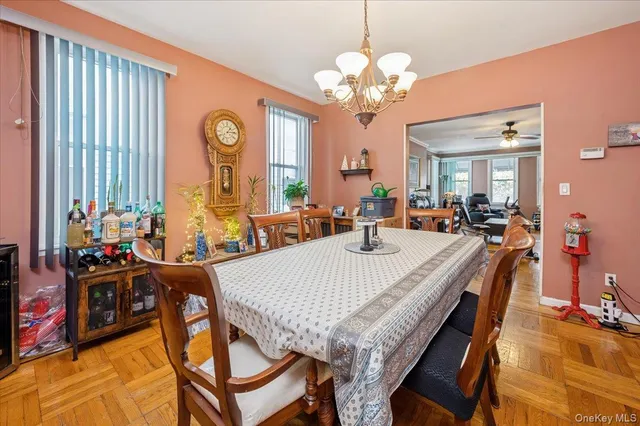 a view of a dining room with furniture and a chandelier