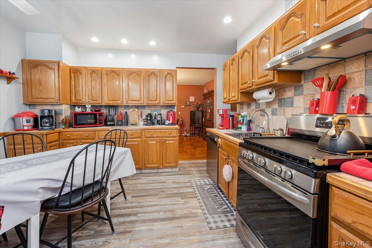 1007 Sacket Avenue Bronx, NY 10462 - Photo 13 of 29 a kitchen with stainless steel appliances granite countertop a stove a sink and a refrigerator