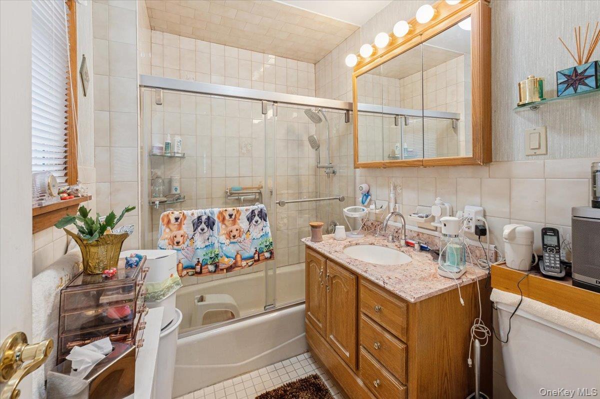 1007 Sacket Avenue Bronx, NY 10462 - Photo 17 of 29 a bathroom with a sink a vanity and a bathtub