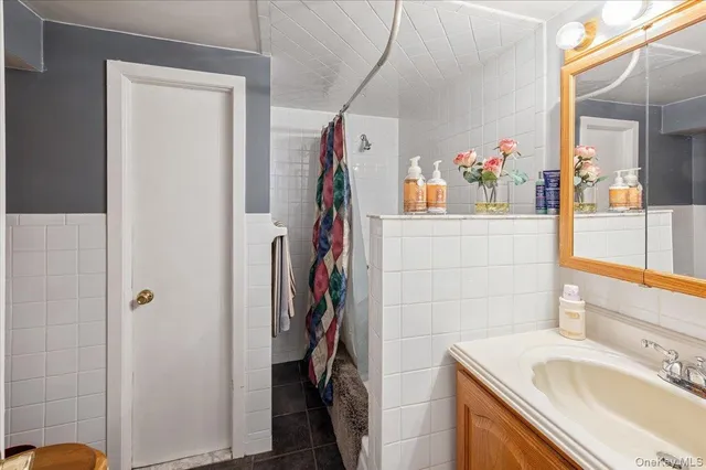a bathroom with a sink vanity and a mirror