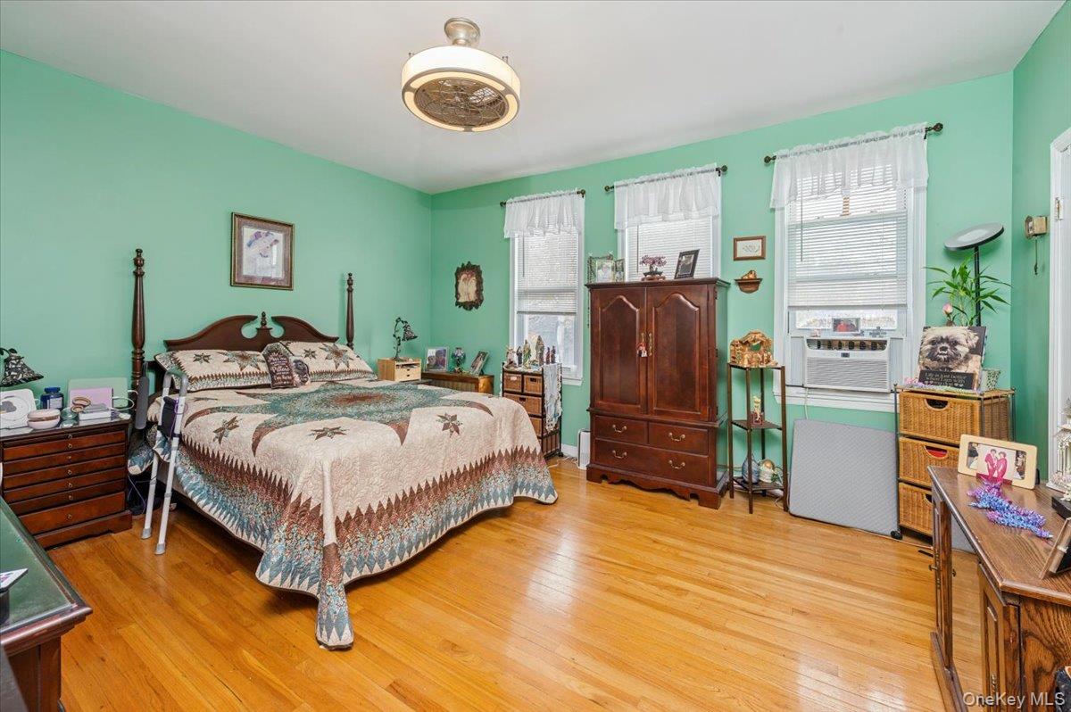 1007 Sacket Avenue Bronx, NY 10462 - Photo 19 of 29 a bedroom with a bed and wooden floor