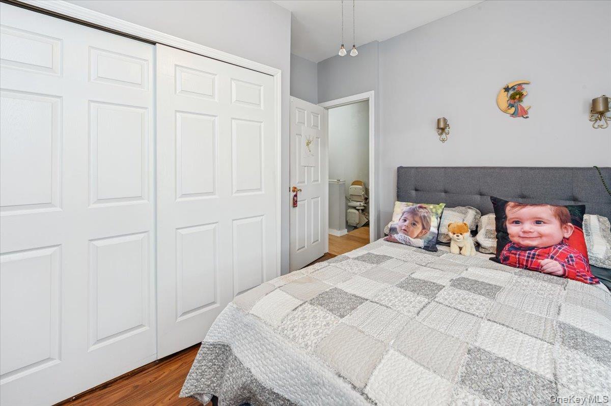 1007 Sacket Avenue Bronx, NY 10462 - Photo 21 of 29 a bedroom with a bed and wooden floor
