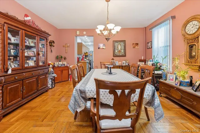 a view of a dining room with furniture a chandelier and wooden floor