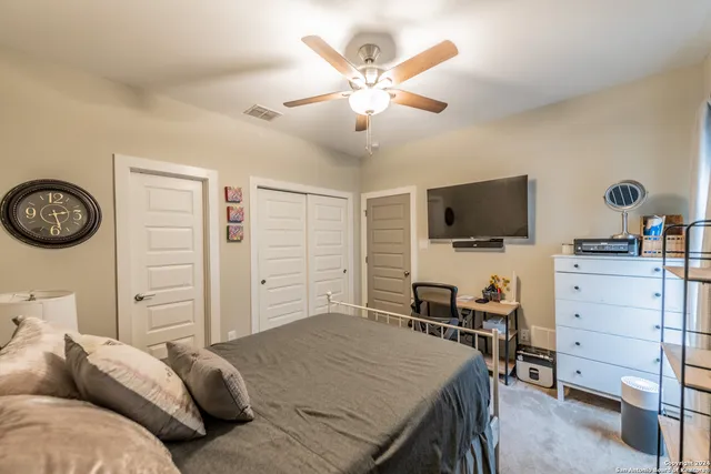 a bedroom with a large bed and a chandelier