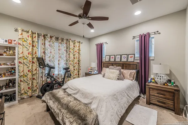 a bedroom with a large bed and a chandelier