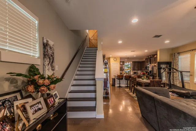 a kitchen with stainless steel appliances granite countertop a sink a stove and a wooden floors
