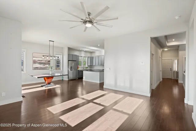 a view of a livingroom with hardwood floor and a ceiling fan