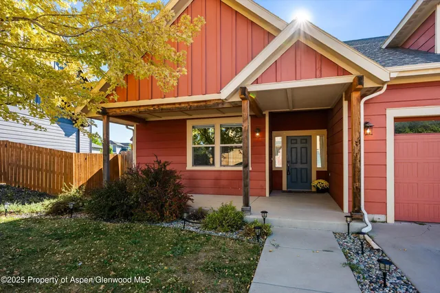 a view of a backyard with wooden fence