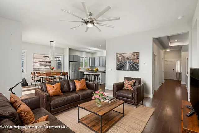 a living room with furniture and a wooden floor