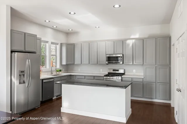 a kitchen with granite countertop a stove and a sink